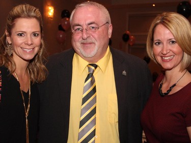 Kanata South Ward Coun. Allan Hubley is flanked by Angie Poirier, left, and Trisha Owens of Majic 100 radio at the Proud to be Bully Free benefit dinner, held at NeXT restaurant on Monday, February 23, 2015.