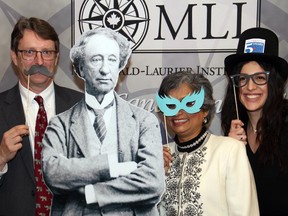 Keith Robinson with his wife, Polytechnics Canada CEO Nobina Robinson, and Stephanie Muccilli posed with their props alongside a cutout of Sir John A. Macdonald at a dinner organized by the Macdonald-Laurier Institute on Wednesday, February 18, 2015, to celebrate the 200th anniversary of the first prime minister's birth.