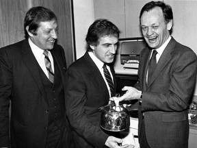 Jean Chretien, right, Roy Romanow, centre, and Roy McMurty, gathered in the kitchen in McMurtry's Toronto two years after the 1981 'Kitchen Accord' to recreate the event.