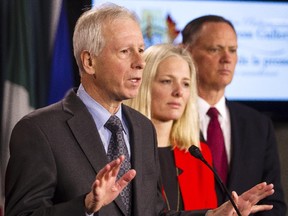 Liberal MP Stephane Dion, left, speaks while Catherine McKenna, Liberal candidate for Ottawa-Centre, center, and David McGuinty, MP for Ottawa-South, look on at a press conference on Parliament Hill to call on the government to reconsider the location of the Memorial to the Victims of Communism Thursday February 26, 2015. (Darren Brown/Ottawa Citizen)