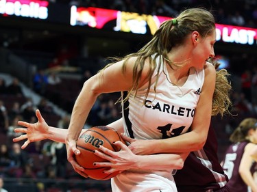 Lindsey Suprunchuk of Carleton Ravens women's basketball team battles of the ball against Krista Van Slingerland of University of Ottawa during first half action.