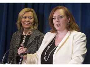 Lisa MacLeod, MPP for Nepean-Carleton and Ontario PC leadership candidate, announced her with withdrawal from the leadership race and threw her support to frontrunner, Christine Elliot (left), at her downtown Ottawa headquarters Friday, Feb. 6, 2015.  (Julie Oliver / Ottawa Citizen)