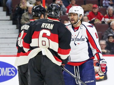 Marc Methot, left, and Bobby Ryan of the Ottawa Senators aren't happy with Alex Ovechkin of the Washington Capitals after the hit that Ovechkin made on Erik Karlsson during second period NHL action.