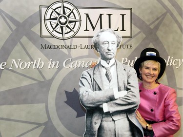 Mary de Toro, chair of the Ottawa branch of the Monarchist League of Canada, poses with a life-size cardboard cutout of Sir John A. Macdonald at a special dinner hosted by the Macdonald-Laurier Institute at the Canadian Museum of History on Wednesday, February 18, 2015.