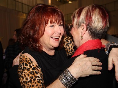 Mary Walsh, left, gives Louise Bradley, president and CEO of the Mental Health Commission of Canada, a warm hug following the specia taping of This Hour has 22 Minutes, held at Algonquin College on Thursday, February 5, 2015, during Cracking-Up the Capital.