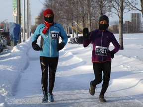 Members of Team Equipe Mosaic run in the Winterman Marathon team relay at the War Museum in Ottawa on Sunday, February 15, 2015.