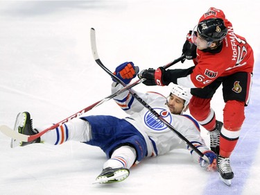 Ottawa Senators' Mike Hoffman, right, hits Edmonton Oilers' Boyd Gordon to the ice during first period NHL hockey action in Ottawa on Saturday, Feb 14, 2015.