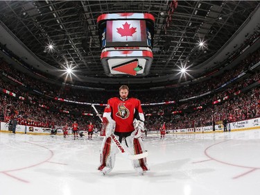 Making his first career NHL start, Andrew Hammond #30 of the Ottawa Senators stands at attention during the singing of the national anthem.