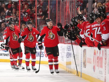 Milan Michalek #9 of the Ottawa Senators celebrates his second period goal against the Montreal Canadiens with teammates at the players' bench.