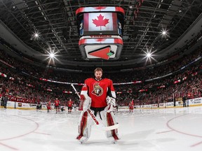 Making his first career NHL start, Andrew Hammond #30 of the Ottawa Senators stands at attention during the singing of the national anthem prior to a game against the Montreal Canadiens at Canadian Tire Centre on February 18, 2015 in Ottawa, Ontario, Canada.