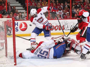 P.K. Subban #76 and Dustin Tokarski #35 of the Montreal Canadiens successfully defend their net against Milan Michalek #9 and Kyle Turris #7 of the Ottawa Senators.