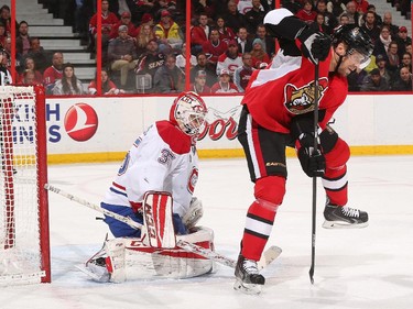 Dustin Tokarski #35 of the Montreal Canadiens guards his net as Milan Michalek #9 of the Ottawa Senators attempts to tip a shot on goal.