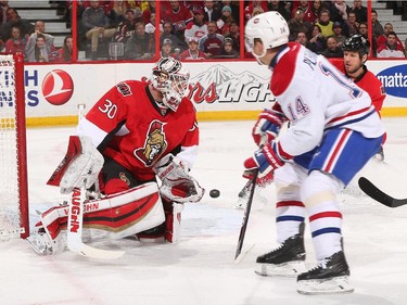 Andrew Hammond #30 of the Ottawa Senators makes a save against Tomas Plekanec #14 of the Montreal Canadiens.