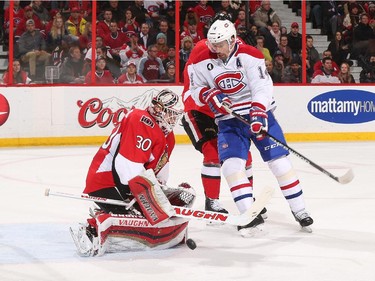 OTTAWA, ON - FEBRUARY 18: Andrew Hammond #30 of the Ottawa Senators makes a save as Tomas Plekanec #14 of the Montreal Canadiens looks to convert the rebound at Canadian Tire Centre on February 18, 2015 in Ottawa, Ontario, Canada.