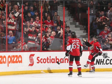 Jean-Gabriel Pageau #44 of the Ottawa Senators celebrates his second period goal against the Montreal Canadiens with teammate Erik Karlsson #65.