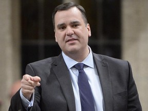 Industry Minister James Moore answers a question during Question Period in the House of Commons in Ottawa, Monday, Feb.2, 2015.