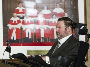 MP Steven Fletcher is photographed in front of a portrait of the Supreme Court Justices, before hearing a historic ruling by the court that it struck down the ban on doctor-assisted suicide Friday February 06, 2015. (Darren Brown/Ottawa Citizen)