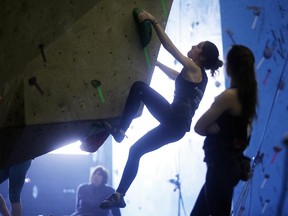 Open category men and women climb in the qualifiers of the Tour de Bloc CRG Winter Classic bouldering competition at Coyote Rock Gym on Saturday, Feb. 7, 2015. In bouldering competitions, coloured tape indicates which holds belong to which problems, and the difficulty of the problem will determine how many points a climber earns for sending it. Now in its 12th season, the Tour de Bloc started in 2003 as a regional competition series in Ontario and Quebec, but has since grown to a full national circuit with stops all across Canada.