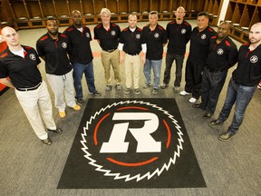 Ottawa RedBlacks coaching staff pose for after a press conference.