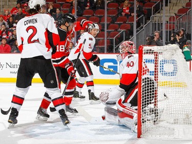 Steve Bernier #18 of the New Jersey Devils celebrates as Jared Cowen #2 and Cody Ceci #5 of the Ottawa Senators watch the puck get past Robin Lehner #40 on a shot from Adam Henrique #14 (not pictured) of the Devils for a second period goal.