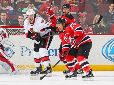 Jared Cowen #2 of the Ottawa Senators playing in his 200th career NHL game skates against Jordin Tootoo #20 of the New Jersey Devils and Dainius Zubrus #8.