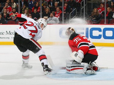 Curtis Lazar #27 of the Ottawa Senators scores on a breakaway against Cory Schneider #35 of the New Jersey Devils.