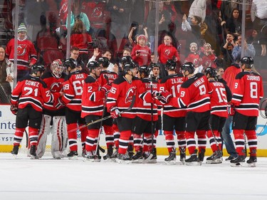 Cory Schneider #35 of the New Jersey Devils is congratulated after defeating the Ottawa Senators.