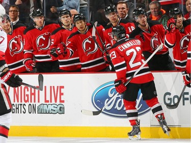Mike Cammalleri #23 of the New Jersey Devils is congratulated by his teammates after scoring a the game-winning goal against the Ottawa Senators.