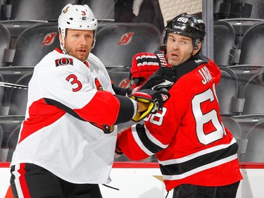 Marc Methot #3 of the Ottawa Senators defends against Jaromir Jagr #68 of the New Jersey Devils during the first period.