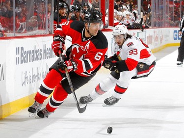 Andy Greene #6 of the New Jersey Devils controls the puck in the first period against Mika Zibanejad #93 of the Ottawa Senators.