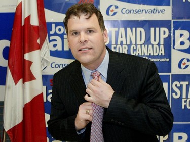 Conservative John Baird checks his tie before having his picture taken at his campaign headquarters on the eve of the election, January 3, 2006.