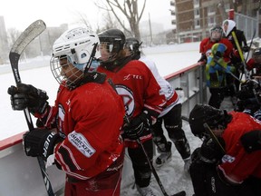 Players get ready to hit the ice at the Hockey Education Reaching Out Society (HEROS) outdoor game against the Christie Lake Kids as part of  celebrating Hockey Day in Canada with Ottawa‚ at risk youth. in Jules Morin Park on Saturday, February 14, 2015.