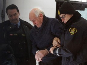 Robert Edgar arrives at the courthouse in L'Orignal, Monday, Feb. 2, 2015. Edgar, pictured being helped out of an OPP paddy-wagon, is charged with murdering his wife Zdenka (Radja) Sekora at their home in Lefaivre.