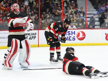 Robin Lehner (L), Marc Methot and Erik Karlsson (R) of the Ottawa Senators show their dejection after the third goal by the Pittsburgh Penguins during second period of NHL action at Canadian Tire Centre in Ottawa, February 12, 2015.