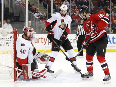 A shot by New Jersey Devils center Adam Henrique, not pictured, enters the net of Ottawa Senators goalie Robin Lehner (40), of Sweden, during the second period.