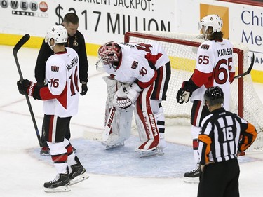 Ottawa Senators goalie Robin Lehner (40), of Sweden, is checked by a trainer during the third period.