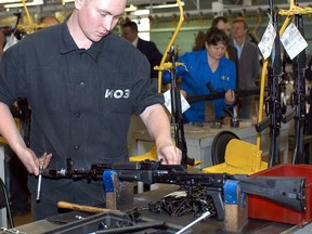 (FILES) A file picture taken on July 26, 2012, shows a worker assembling Kalashnikov assault rifles at Izhmash weapons factory, the home of the legendary rifle, in Izhevsk. Russia is considering creating a single firearms manufacturer named after the legendary rifle designer Mikhail Kalashnikov by merging two struggling firms, President Vladimir Putin said on today.