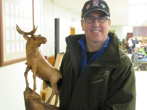 Sarnia resident Chad Vollrath with a carving of a moose done by this great-grandfather, Charles Vollrath.