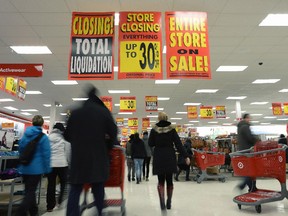 Shoppers flock to a Target store in Ottawa on Thursday as the company began liquidating its Canadian assets.