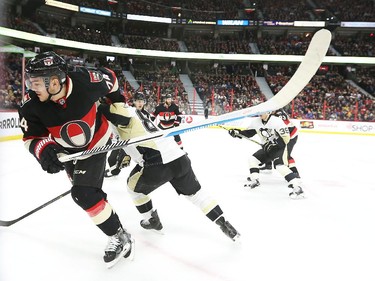 Sidney Crosby of the Pittsburgh Penguins battles against Mark Borowiecki of the Ottawa Senators during second period of NHL action at Canadian Tire Centre in Ottawa, February 12, 2015.
