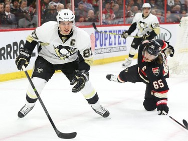Sidney Crosby of the Pittsburgh Penguins in the offensive zone against Erik Karlsson (65) of the Ottawa Senators during second period of NHL action at Canadian Tire Centre in Ottawa, February 12, 2015.  (Jean Levac/ Ottawa Citizen)