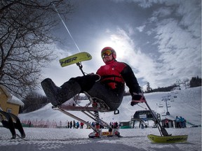 Sit ski instructor Andy Van Grunsven, a C7 quadriplegic, is silhouetted against the ski hill as he gets set to instruct others as 21 injured military persons took part in the 5th annual Winter Sports Clinic for Injured Soldiers at Calabogie Peaks Resort.