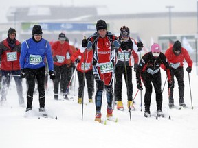 Skiers at the beginning of the Gatineau Loppet in Gatineau, Saturday, Feb. 14, 2015. Competitors braved falling snow plus bone-chilling temperatures to participate.