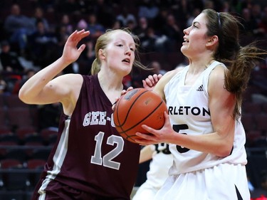 Stephanie Carr of the Carleton Ravens drives the ball passed Jennifer Crowe of University of Ottawa during first half action.