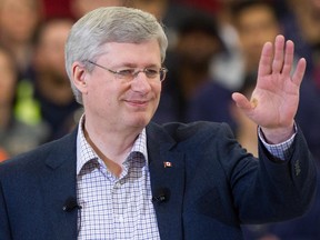 Prime Minister Stephen Harper waves as he arrives to speak during an announcement about the apprentice loan program at the British Columbia Institute of Technology Annacis Island Campus in Delta, B.C., on Thursday January 8, 2015.