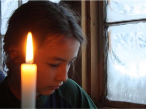 Suzanne Crocker's daughter Sam reads by candlight in a scene from All the Time in the World.