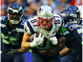 Rob Gronkowski #87 of the New England Patriots carries the ball against  Kam Chancellor #31 of the Seattle Seahawks in the first quarter during Super Bowl XLIX at University of Phoenix Stadium on February 1, 2015 in Glendale, Arizona.