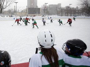 Teams skate around during the Hockey Education Reaching Out Society (HEROS) outdoor game against the Christie Lake Kids as part of  celebrating Hockey Day in Canada with Ottawa‚Äôs at risk youth. in Jules Morin Park on Saturday, February 14, 2015. (Cole Burston/Ottawa Citizen)