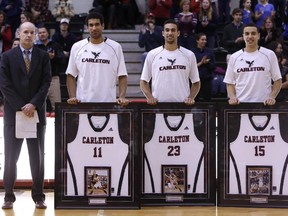 The Carleton Ravens and head coach Dave Smart honoured, from left, Thomas Scrubb, Philip Scrubb and Victor Raso before their last regular season home game, at the Carleton University Raven's Nest on Feb. 21, 2015.
