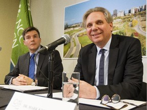 The National Capital Commission's Pierre Lanctot, executive director of corporate services, left, looks on as Mark Kristmanson, NCC CEO, speaks during a press conference to announce the shortlist of developers for Lebreton Flats Wednesday February 18, 2015. (Darren Brown/Ottawa Citizen)
